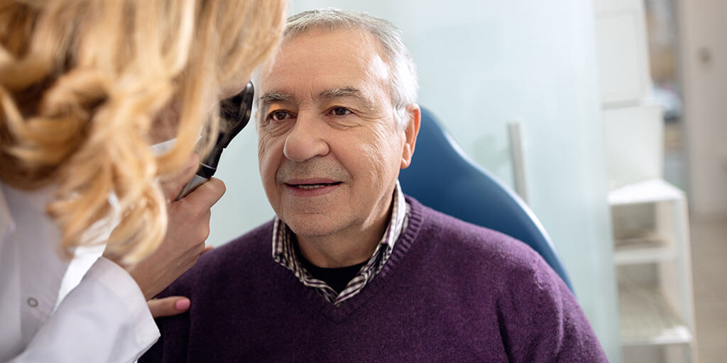 Older man getting an eye exam